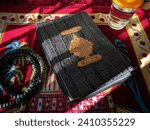 Small photo of Yogyakarta, Indonesia - December 21, 2023 : Holy Quran with written arabic calligraphy meaning of Al Quran and rosary beads or tasbih. Wrote on it "Al Quran Al Karim" in Arabic. Islamic concept