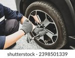 Small photo of Auto mechanic use wrench to repairing and change car tires. Concept of car care service and maintenance or fix the car leaky or flat tire.