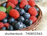 Fresh organic blueberries and raspberries in a basket.Blueberry and raspberry.Healthy eating,diet concept.Selective focus.