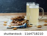 Rustic background for Oktoberfest or Bavarian specialties with white and blue fabric, beer glass and pretzels on wooden table. Menu card for Restaurants. vintage toned