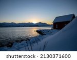 sunset in Skaland on island Senja in northern Norway in winter
