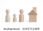 Wooden figurines of family father, mother, children. Wooden figurines concept. model house on a white background. Real estate purchase, rental concept. warm family concept.