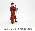 Small photo of Harry Potter dressed in Hogwarts school uniform of quidditch game. Collectible toy for children. Character from the J. K. Rowling. Broom. Golden snitch ball.