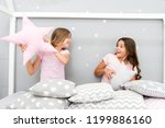 Small photo of Girls sleepover party ideas. Soulmates girls having fun sleepover party. Girls happy best friends in pajamas with pillows sleepover party. Pillow fight pajama party. Sleepover time for pillow fight.