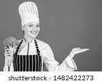 Small photo of For a truly healthy and enjoyable dish. Kitchen maid gesturing away with healthy green broccoli in hand. Happy cook choosing cabbage for healthy diet. Presenting healthy product, copy space.