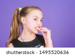 Small photo of Sweet tooth concept. Kid girl with long hair likes sweets and treats. Calorie and diet. Incorrigible sweet tooth. Hungry kid. Girl smiling face holds sweet marshmallows in hand violet background.