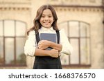Small photo of Little expert in books. Happy girl hold library book outdoor. School bibliopole. Bibliopole and bibliomania. Bibliopole and librarian. Bibliopole or book dealer. Small bookworm. Second-hand bookstore.