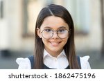 Small photo of Smart at first sight. Happy kid wear eyeglasses outdoors. Sight test. Eye examination. Pediatric ophthalmology. Fashion eyewear. Trendy glasses. Vision correction. Optician salon. School education.