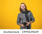 Small photo of A true shutterbug. Photographer yellow background. Photographer hold photo camera.