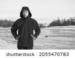 Christmas vacation. human and nature. man walking snowy landscape in sunset. travel and expedition concept. man in red parka. winter male fashion. warm clothes for cold climate. weather forecast