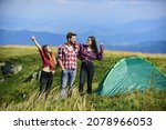Camping gear. Camping equipment. Weekend in mountains. Man and girls having fun in nature. Camping tent. Feel freedom. Happiness concept. Hiking activity. Friends set up tent on top mountain