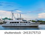 Small photo of Private white luxury anchored off the beach. Summer vacation. Summertime yachting. Yacht vacation in summer. A luxury private motor yacht in sea harbor. Yacht in navigation. Superyacht