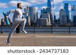 Small photo of Morning sport workout jogger run in New York. The jogger run at sport training. Sportsman jogger running or jogging. Man in sports suit training jogging. Running man in Manhattan. Copy space