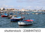 Small photo of Molfetta, Metropolitan city of Bari, Italy - 24 september 2023: The port, of the cargo-fishing type, ans the basilica of the Madonna dei Martiri