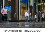 Small photo of NEW YORK, USA - May 03, 2016: Manhattan street scene. Group of company employees in Manhattan during cigarette break in front of companys office