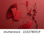 Chinese New Year background with paper fans, lucky envelopes, flower branches, and lucky ornaments. Asia holiday
