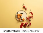Small photo of Chinese new year holiday background stylish with tangerine, Blossom, mandarin orange, and lucky ornaments. Empty space for text