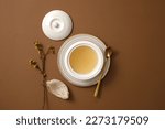 Small photo of A bowl with bird’s nest soup inside placed on a plate and an edible bird’s nest next to it. Blank space to add text or product. Bird’s nest is very well-known in Southeast Asia as a healthy dessert