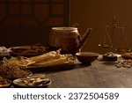 Scenes of many oriental medicines are displayed on a wooden background, decorated with medicine pot, bowl and a small ancient scale. Background for advertising with the concept of folk medicine