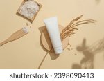 Unbranded cosmetic tube highlights on a minimalist beige backdrop. Crafting a vegan cosmetics brand with primary ingredients sourced from rice bran. Ample copy space.
