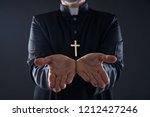 Small photo of Priest open hands arms praying offering oblation