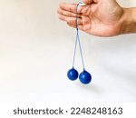Small photo of Clackers Balls “Lato-lato” toys made from 2 polymer balls tied with rope, Indonesian viral kids toys in the end of 2022. Everyone playing this famous game. Clickers,Clackers, Knockers, Click Clacks