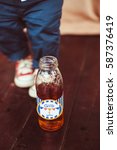 Small photo of Bottle with lettering 'Glib 1 year' stands before a kid