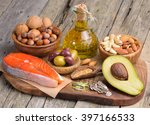 Selection of healthy fat sources on wooden table. 