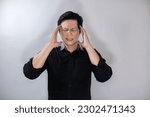 Small photo of Adult Asian man wearing black shirt with giddy expression