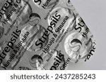 Small photo of Espoo, Finland - April 2020: Strepsils - sugar free lemon and menthol tasting drug helping with sore throat, cold and flu. This medication relieves pain and creates comfort. Closeup color image.