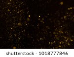 Gold glitter falling sparkle background on black