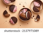 Small photo of Whoopie pie desserts in boxes on beige background