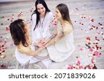 Women's Recovery Group. Diverse Girls Smiling Holding Hands Sitting In Circle Indoor. Selective Focus. Women hug in a women's circle