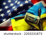 Small photo of American and Ukrainian flags, a pack of American dollars. Aid lend-lease concept.