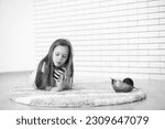 little girl lies on the floor and eats an apple
