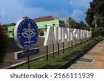 Small photo of Bogor, west java Indonesia-June 10, 2022 : Faculty of Economics and Management (FEM) of Bogor Agricultural University creating white and yellow signage letter standing on the grass