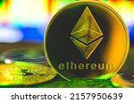 World cryptocurrency. Ethereum coin in yellow-green neon light close-up. Financial system of the future