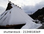 Thatched Roof Covered With Snow