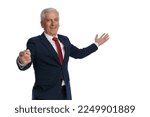 Old businessman pointing finger at the camera while pointing the other hand to the side and smiling