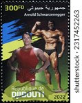 Small photo of Milan, Italy – February 18, 2023: Bodybuilder Arnold Schwarzenegger on postage stamp