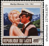 Small photo of Milan, Italy – September 22, 2022: Tony Curtis and Marilyn Monroe on postage stamp