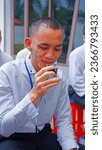 Small photo of Jakarta, Indonesia - 17 August 2023: grown men savour the aroma of speciality coffee from Indonesia