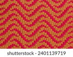 Yellow pink crochet mosaic fabric with abstract pattern. Knitted background.