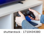 Woman hands with a game controller, relaxation at home,  closeup