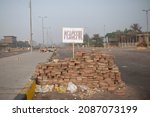 Small photo of Cairo, Egypt - July 03 2013: Stone barricade erected by demonstrators on Anwar Sadat street. Above the barricade is the inscription we want peace.