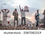 Small photo of Cairo, Egypt - July 03 2013:The demonstrators removed the paving stones and set up barricades against the police. They are demonstrating on the barricade with a Morsi poster in their hands.