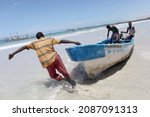 Small photo of Mogadishu, Somalia - September 28, 2011 - Fishermen pull the boat towards the water. They will go out to sea to fish.