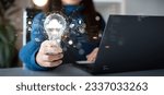 Small photo of Woman holding light bulb with cloud icon. Digital technology concept, data sheet management with large database capacity and high security. Storage transition from computer to cloud computing.