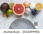 Metabolism-boosting foods: eggs, grapefruit, avocado, blueberries, onions, garlic, nuts, kiwi.  Top view