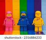Small photo of Tambov, Russian Federation - November 07, 2022 Three Lego astronaut minifigures - Benny, Lenny, Kenny, standing on a rainbow backdrop.